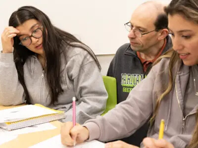 professor and students reviewing work