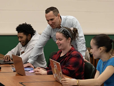 male teacher and three students