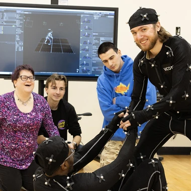 five students working on a compute game